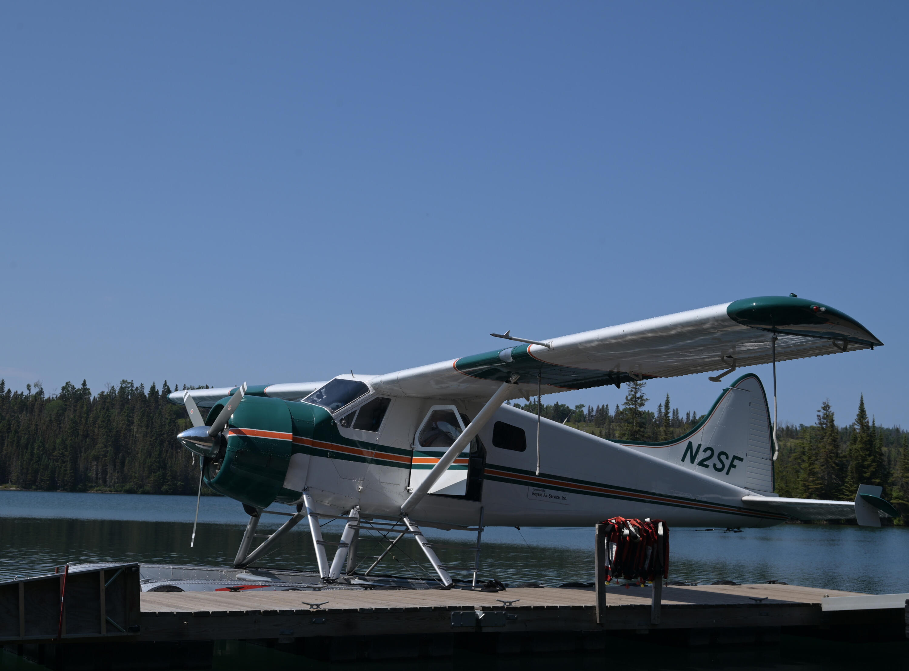 A photo of a white float / sea plane docked in Tobin Harbor / Rock Harbor in Isle Royale National Park